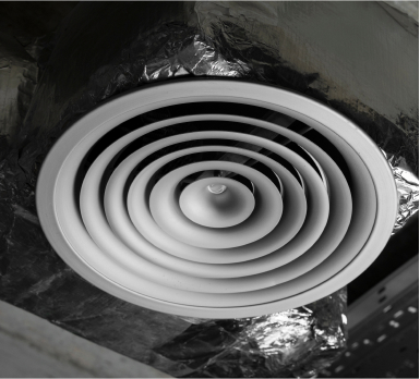 Circular air vent with visible dust and debris buildup, emphasizing the need for professional air duct cleaning services.