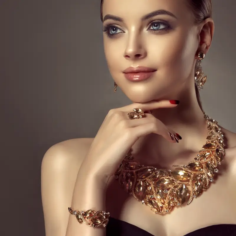 This image features a woman smiling brightly while wearing a beautiful diamond necklace and earrings