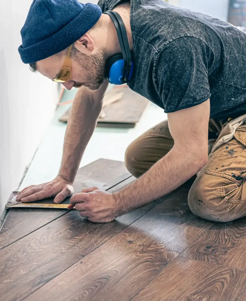 Skilled worker installing laminate flooring