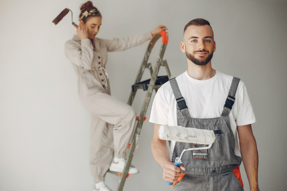 Young couple repairing a room